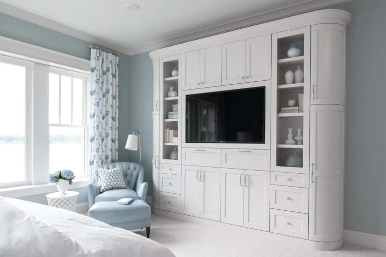 blue bedroom with white entertainment center