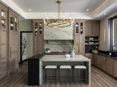 continous granite island with light wood cabinets