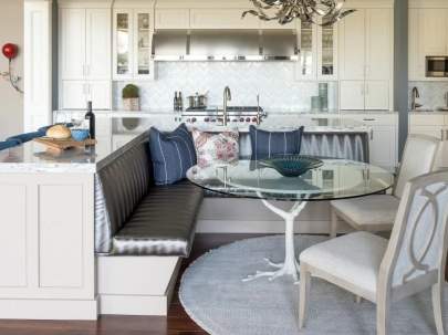 off white cabinetry with L shaped island dual serving as a table area