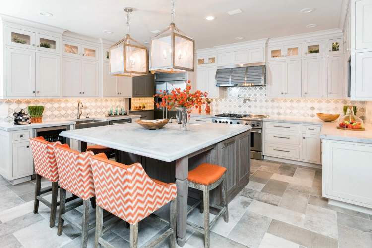 white cabinetry with a weathered gray island and orange chairs