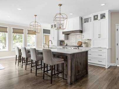 white cabinets with Dark island and gray chairs