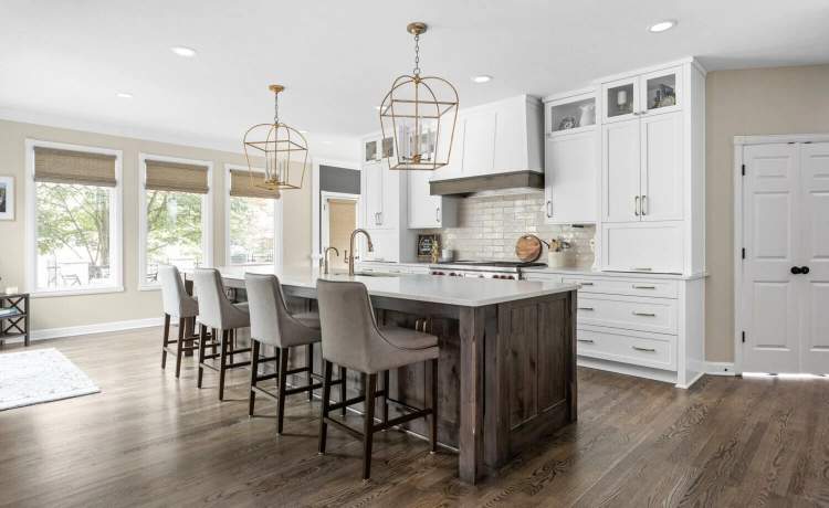 white cabinets with Dark island and gray chairs